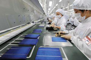 Chinese factory workers at the plant of Astronergy Solar Energy Technology Co., Ltd. Photo Credit: Associated Press.