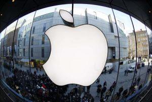 File photo of people waiting on street in front of Apple store as they await sales of new iPad in Apple store in Munich