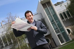 Dr Scott Watkins holding a sheet of flexible solar cells. Credit: CSIRO
