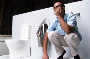 Graduate student Clement Cid with the Caltech team's solar-powered toilet. Credit: Caltech