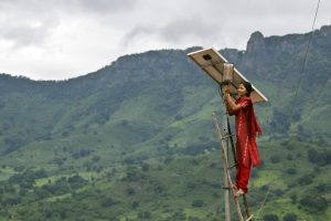 Meenakshi Dewan tends to maintenance work on the solar street lighting in her village of Tinginaput, India. Huge pylons run across these hills, supplying power to the big cities – but rural areas like this are not connected to the main grid.
(Courtesy of UK Department for International Development/CC BY-NC-ND 2.0)