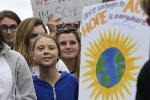 Swedish youth climate activist Greta Thunberg, center in blue, joins other young climate activists Friday for a climate strike outside the White House in Washington, Friday, Sept. 13, 2019. (AP Photo/Susan Walsh)
